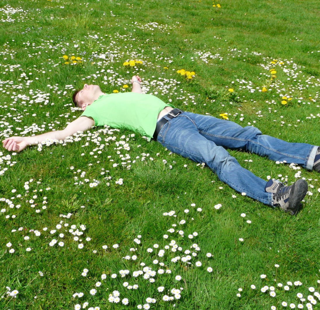 man sleeping happily on the park ground